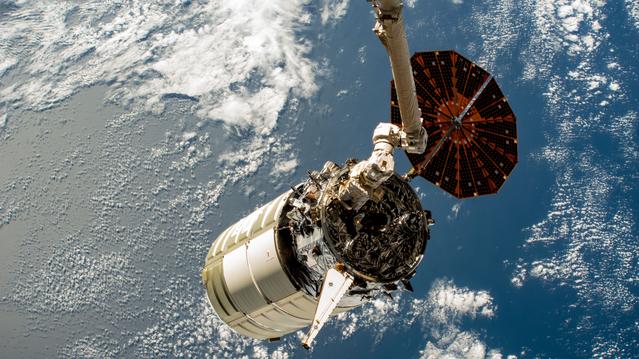NASA image: The Cygnus space freighter in the grip of the Canadarm2 robotic arm
