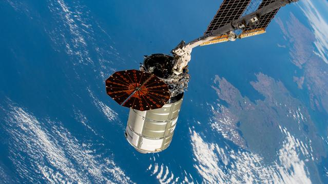 NASA image: The Cygnus space freighter in the grip of the Canadarm2 robotic arm