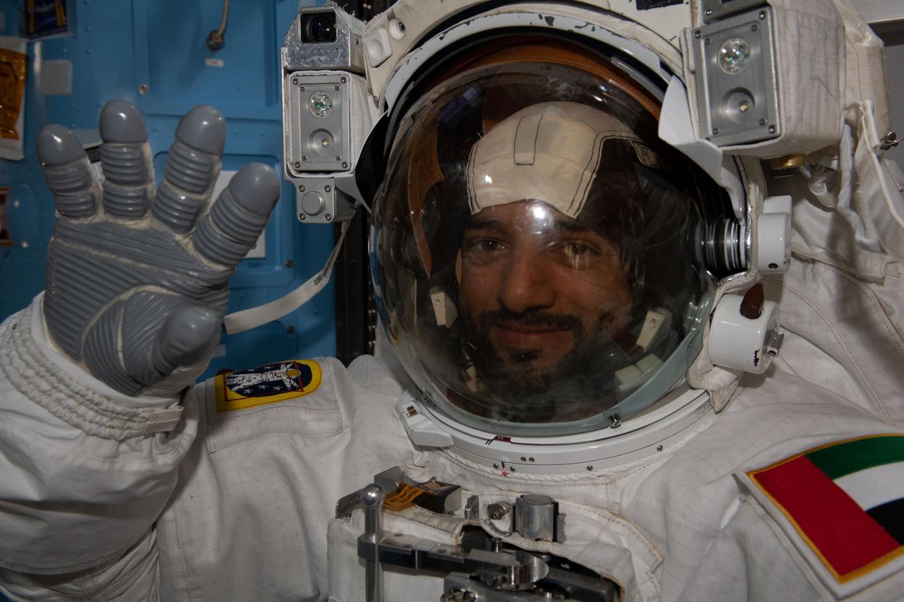 iss069e005102 (April 24, 2023) --- UAE (United Arab Emirates) astronaut and Expedition 69 Flight Engineer Sultan Alneyadi is pictured trying on his Extravehicular Mobility Unit, or spacesuit, and testing it ahead of a spacewalk planned for Friday, April 28. Alneyadi, along with NASA astronaut Stephen Bowen, will spend about six-and-a-half hours in the vacuum of space continuing to upgrade the International Space Station’s power generation system readying the orbiting lab for its next set of roll-out solar arrays.