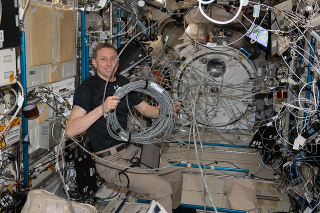 NASA image: Astronaut Woody Hoburg reconfigures video cables