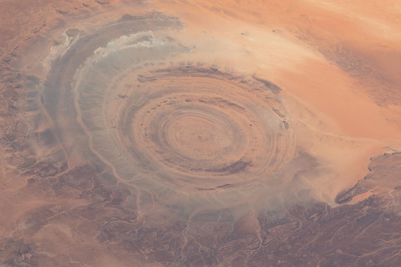 iss069e005471 (April 26, 2023) --- The Richat Structure, also known as the "Eye of the Sahara," an eroded geological dome in the nation of Mauritania, is pictured from the International Space Station as it orbited 259 miles above the African continent.