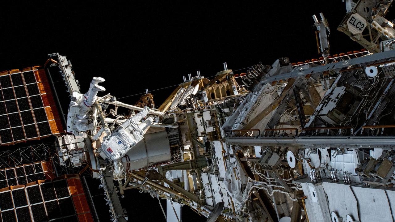 iss069e005734 (April 28, 2023) --- NASA astronaut Stephen Bowen and UAE (United Arab Emirates) astronaut Sultan Alneyadi are pictured in their Extravehicular Mobility Units, or spacesuits, on the International Space Station's starboard truss structure during a spacewalk. The duo would spend seven hours and one minute in the vacuum of space routing cables and installing insulation readying the orbital outpost for its next set of roll-out solar arrays due to be installed after their delivery on the next SpaceX Dragon cargo mission.