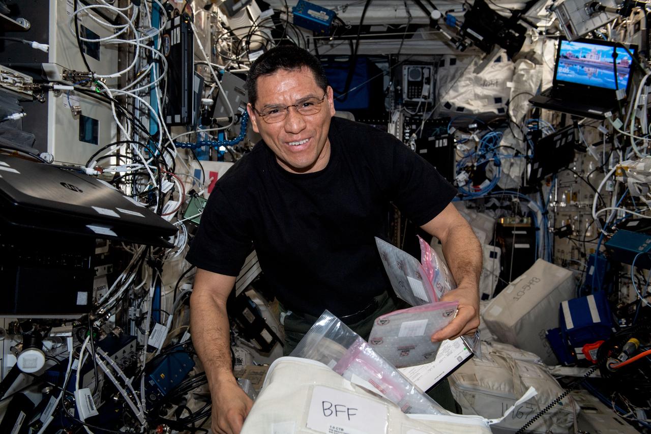 iss069e008316 (May 2, 2023) --- NASA astronaut and Expedition 69 Flight Engineer Frank Rubio unpacks gear he will use to replace and install components inside the BioFabrication Facility, a research device designed to print organ-like tissues in microgravity and learn how to manufacture whole, fully-functioning human organs in space.
