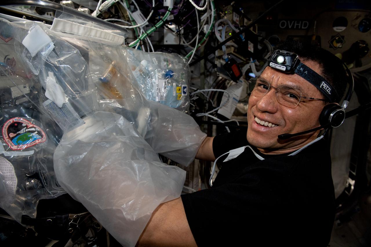iss069e00827 (May 2, 2023) --- NASA astronaut and Expedition 69 Flight Engineer Frank Rubio uses a glovebag and services the BioFabrication Facility, replacing and installing components inside the research device designed to print organ-like tissues in microgravity and learn how to manufacture whole, fully-functioning human organs in space.