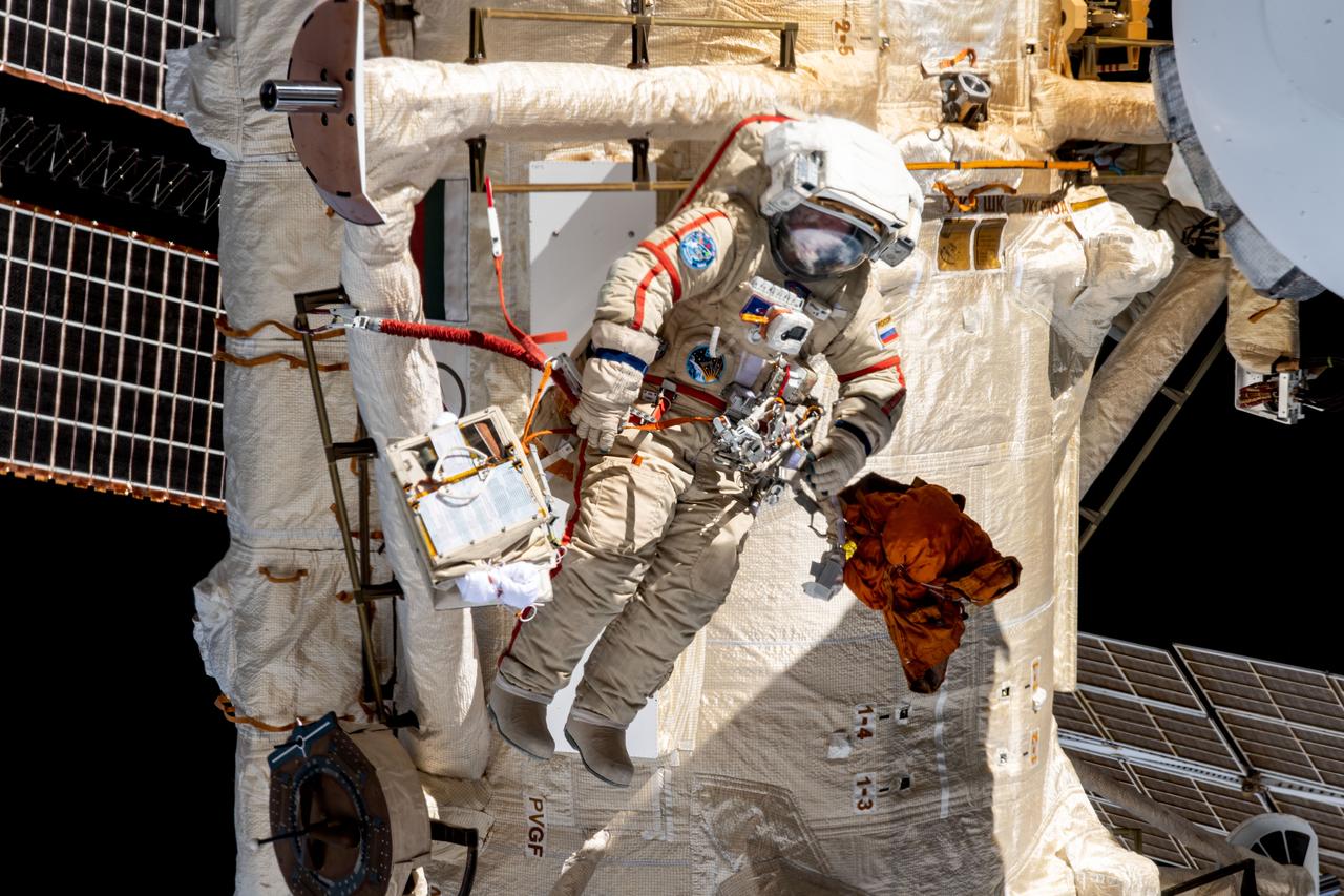 iss069e008728 (May 3, 2023) --- Roscosmos spacewalker Sergey Prokopyev works outside the International Space Station's Roscosmos segment during the installation of an experiment airlock on the Nauka multipurpose laboratory module.