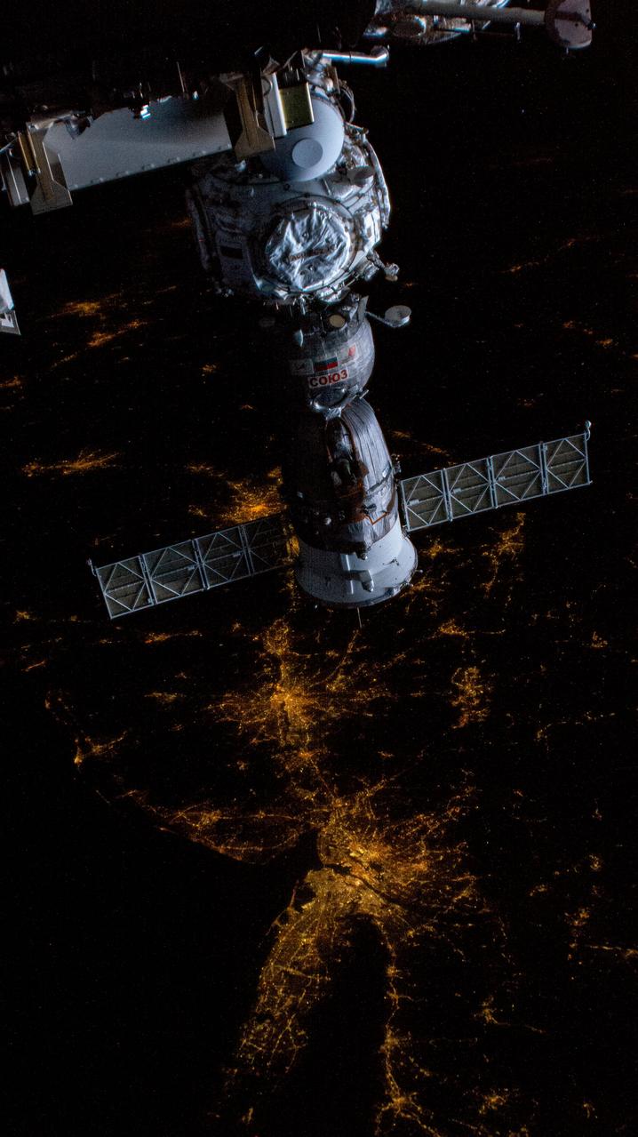 iss069e010181 (May 12, 2023) --- The Soyuz MS-23 crew ship is pictured docked to the Prichal docking module as the International Space Station orbited 261 miles above the northeast coast of the United States. The city lights of New York City and the surrounding metropolitan area are easily visible from the orbital outpost.