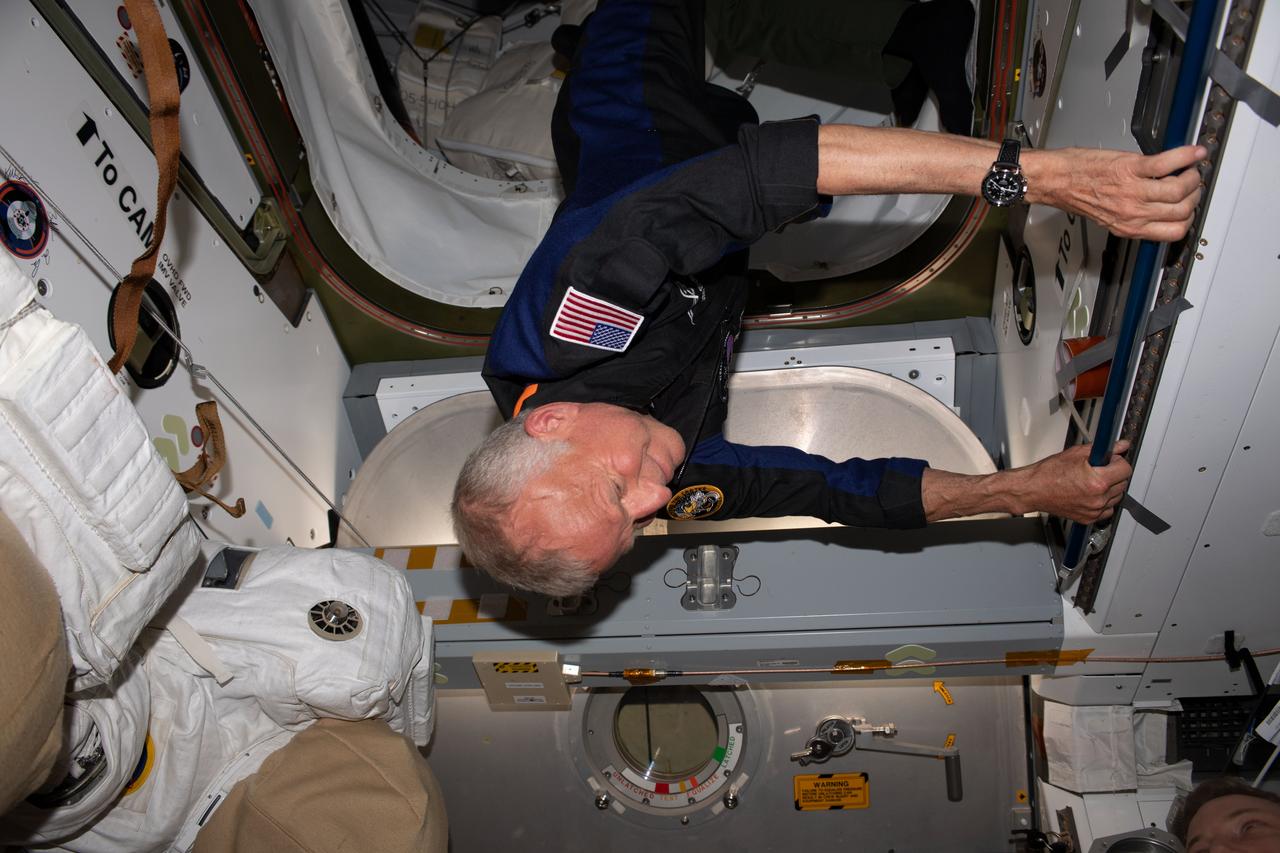 iss069e013992 (May 22, 2023) --- Axiom Space private astronaut and Axiom Mission-2 Pilot John Shoffner enters the International Space Station shortly after the hatches were opened between the orbital outpost and the SpaceX Dragon Freedom spacecraft.