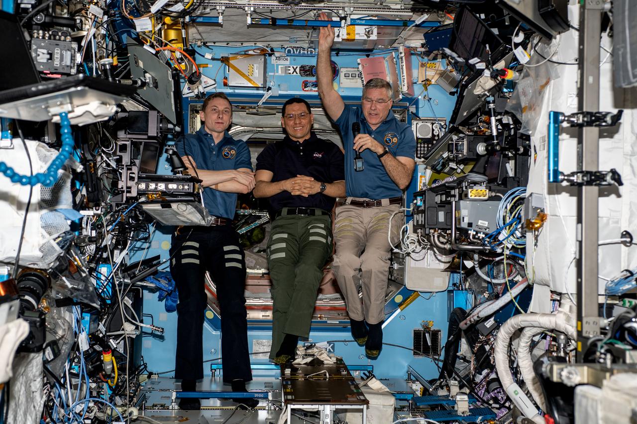 iss069e014347 (May 25, 2023) --- Expedition 69 Flight Engineers Woody Hoburg, Frank Rubio, and Stephen Bowen, all from NASA, gather inside the International Space Station's Destiny laboratory module and speak to U.S. elementary and junior high school students on Earth.