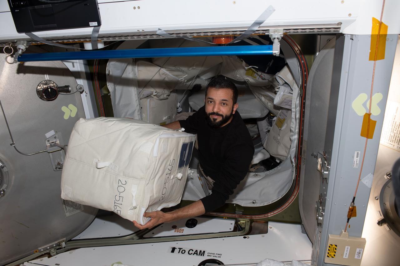 iss069e018207 (June 6, 2023) --- UAE (United Arab Emirates) astronaut and Expedition 69 Flight Engineer Sultan Alneyadi begins unloading cargo from the SpaceX Dragon cargo vehicle shortly after it docked to the International Space Station on June 6, 2023.