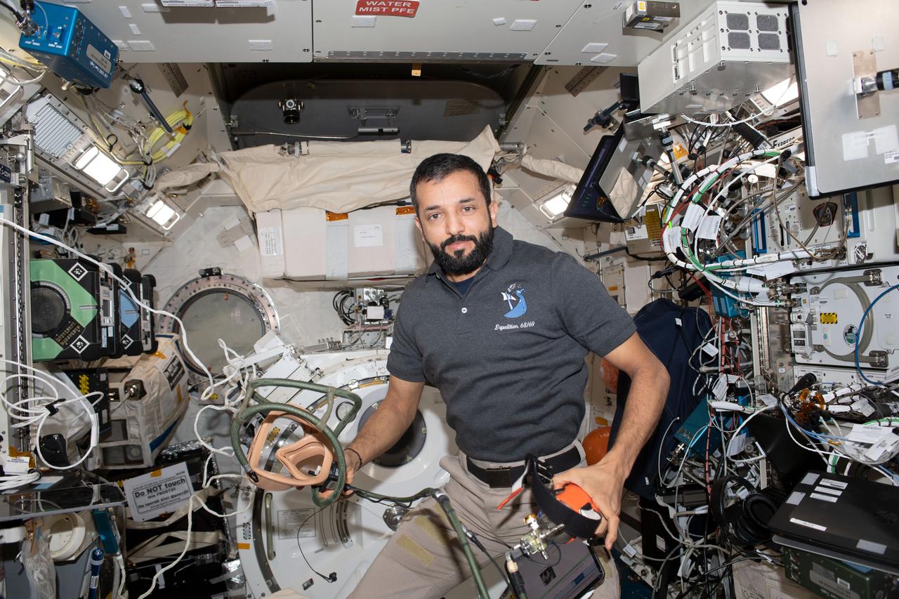 iss069e019758_alt (June 20, 2023) --- UAE (United Arab Emirates) astronaut and Expedition 69 Flight Engineer Sultan Alneyadi is pictured holding portable breathing gear inside the International Space Station's Kibo laboratory module.