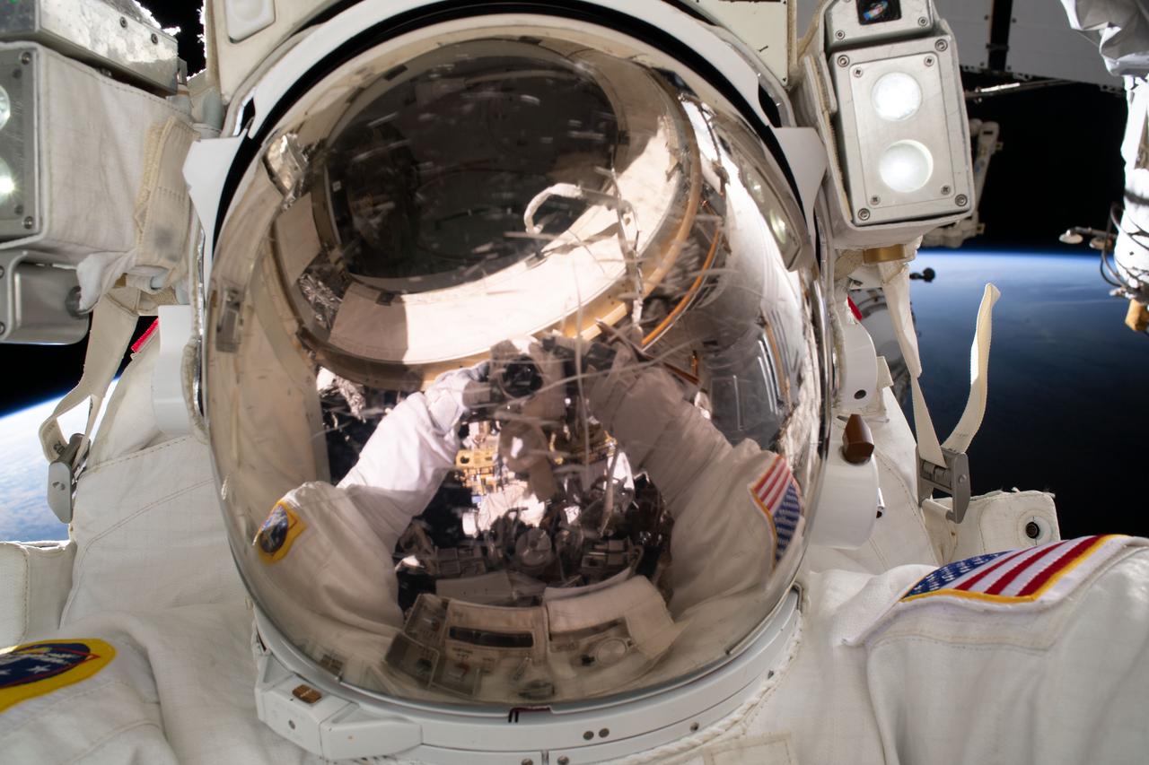 iss069e020708 (June 15, 2023) --- NASA astronaut and Expedition 68 Flight Engineer Woody Hoburg points the camera toward himself and takes an out-of-this-world "space-selfie" during a five-hour and 35-minute spacewalk to install a roll-out solar array on the International Space Station's truss structure.