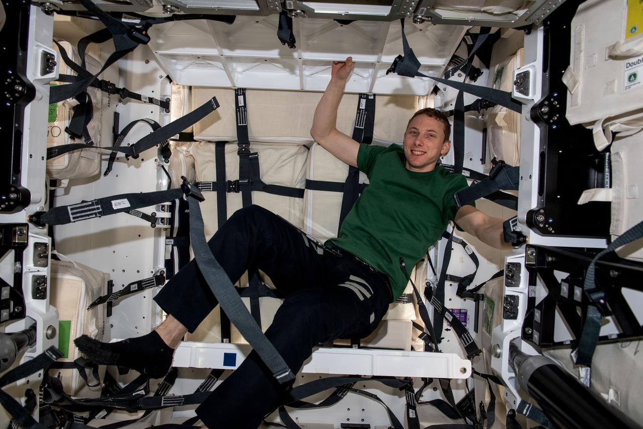 iss069e024290 (June 22, 2023) --- NASA astronaut and Expedition 69 Flight Engineer Woody Hoburg is pictured loading cargo inside the SpaceX Dragon cargo vehicle.
