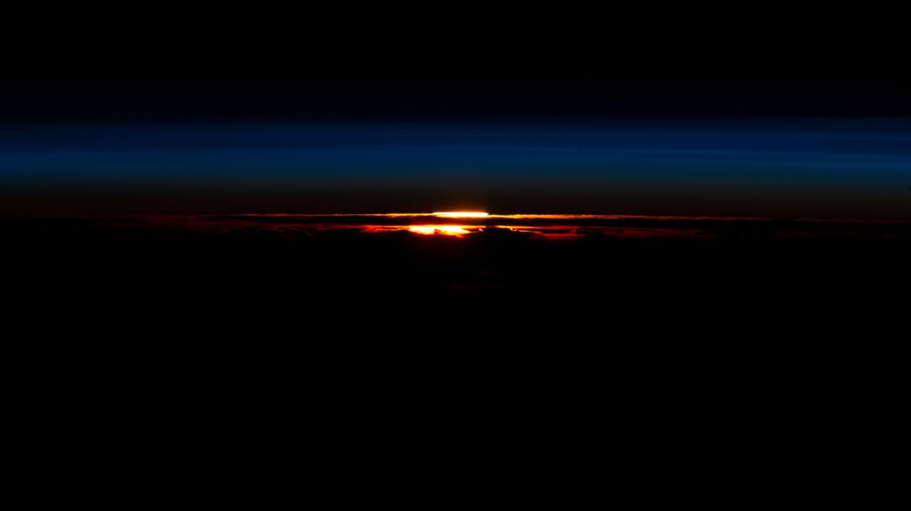 iss069e025337 (June 24, 2023) --- The last rays of an orbital sunset begin fading in Earth's atmosphere silhouetting the cloud tops in this photograph from the International Space Station as it orbited 271 miles above the southernmost tip of South America.