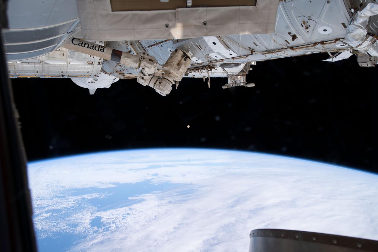 iss069e027342 (July 2, 2023) -- An almost-full moon glows in the back as the space station orbits 268 miles above the coast of Argentina.