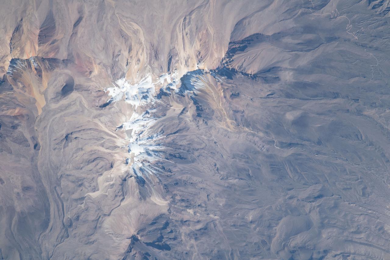 iss069e028771 (July 4, 2023) --- The snow-covered peak of the extinct Volcano Chachani is pictured from the International Space Station as it orbited 261 miles above the Peruvian Andes on the South American continent.