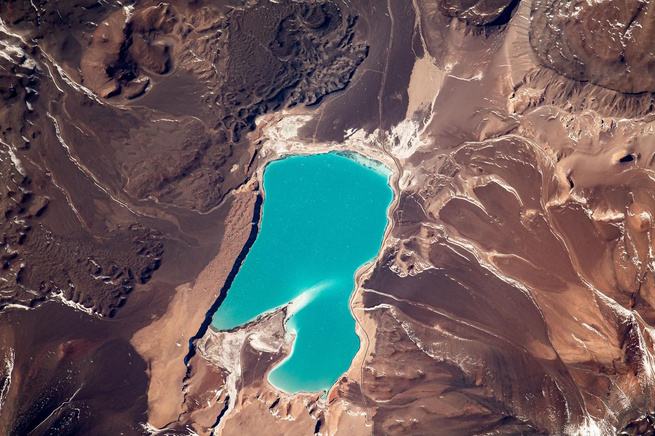 iss069e030011 (July 7, 2023) --- Laguna Verde, a high-altitude lake in the Andes mountains of Chile near the world's highest volcano Ojos del Salado, is pictured from the International Space Station as it orbited 264 miles above.