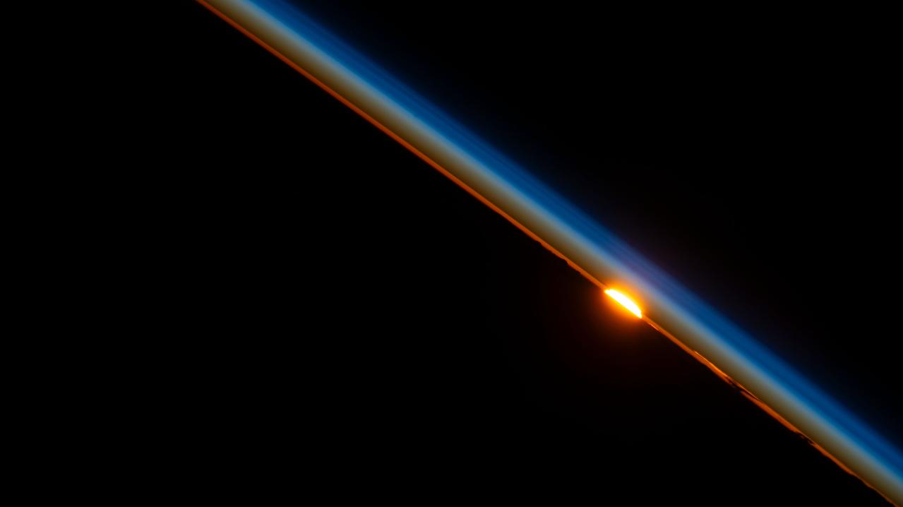 iss069e030598 (July 9, 2023) --- The last rays of an orbital sunset dim in the Earth's atmosphere as the International Space Station orbited above Niger on the African continent.