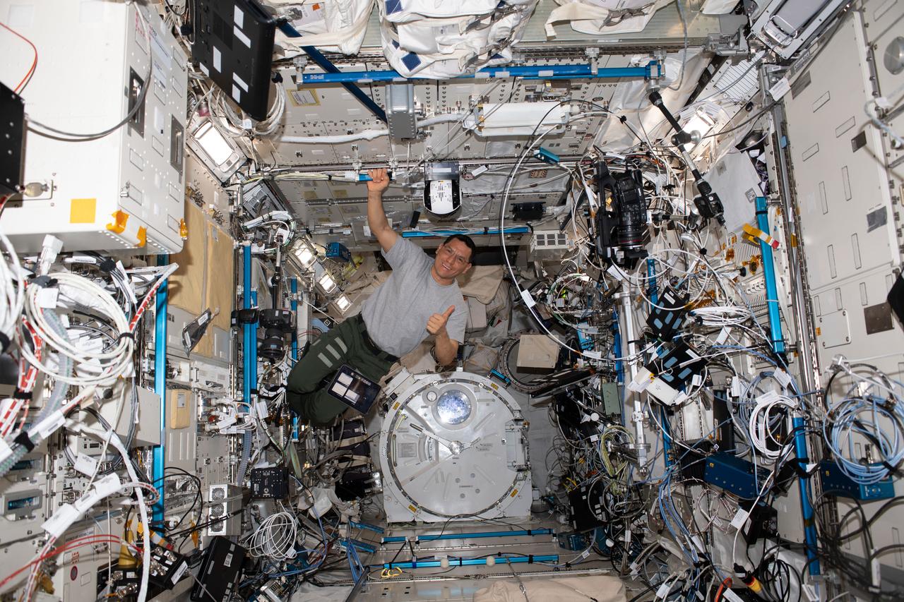 iss069e031074 (July 11, 2023) --- NASA astronaut and Expedition 69 Flight Engineer Frank Rubio is pictured setting up robotic camera hardware inside the International Space Station's Kibo laboratory module.