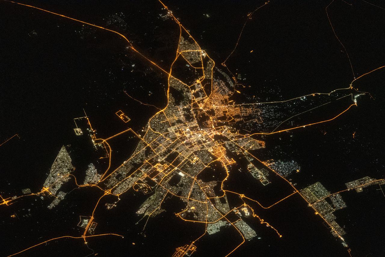 iss069e032977 (July 18, 2023) --- The city lights of the oasis city of Al Ain in the United Arab Emirates are pictured from the International Space Station as it orbited 260 miles above southern Iran near the coast of the Strait of Hormuz.