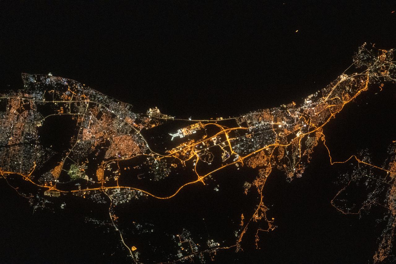 iss069e032988 (July 18, 2023) --- The city light's of the port capital of Muscat, Oman, including the coastal fishing province of Al-Seeb, are pictured from the International Space Station as it orbited 260 miles above the Gulf of Oman. Muscat International Airport is featured prominently in the middle of this photograph.