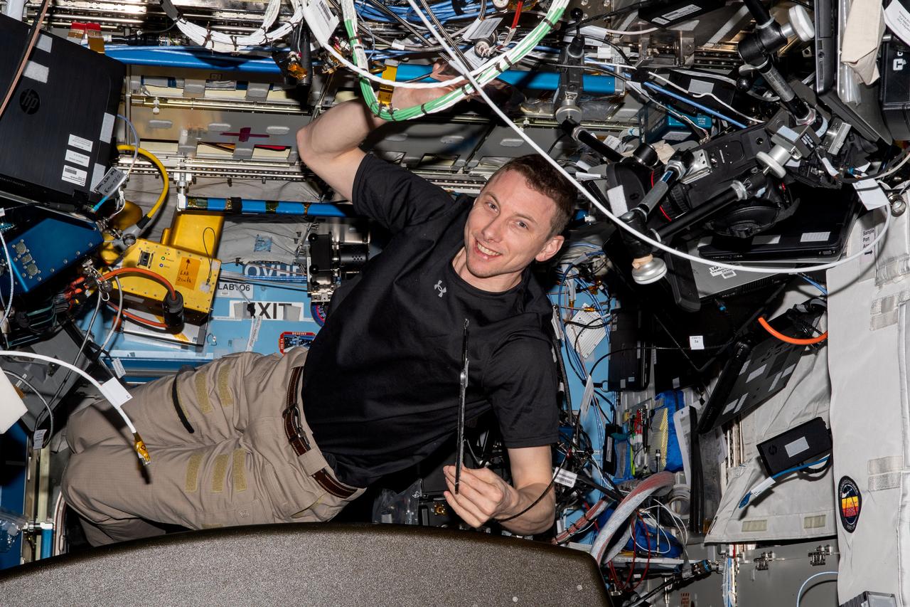 iss069e033729 (July 18, 2023) -- NASA astronaut and Expedition 69 Flight Engineer Woody Hoburg poses for a photo inside the Destiny module as he installs electronics and communications hardware.