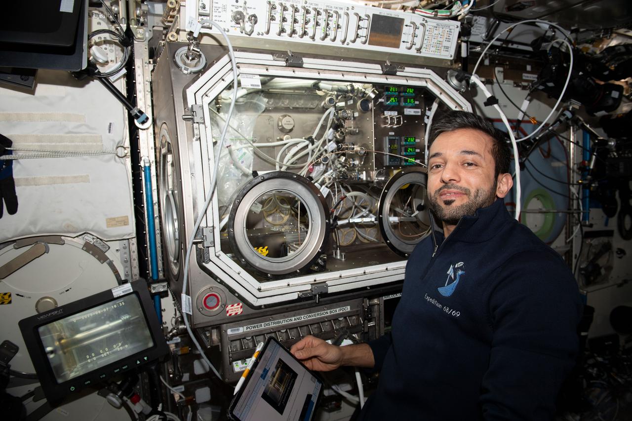 iss069e054948 (Aug. 7, 2023) --- UAE (United Arab Emirates) astronaut and Expedition 69 Flight Engineer Sultan Alneyadi sets up physics research hardware in the Destiny laboratory module's Microgravity Science Glovebox. The investigation seeks to create a superior graphene aerogel, a synthetic material with high porosity and low density, in microgravity benefitting both Earth and space industries such as power storage, environmental protection, and chemical sensing.