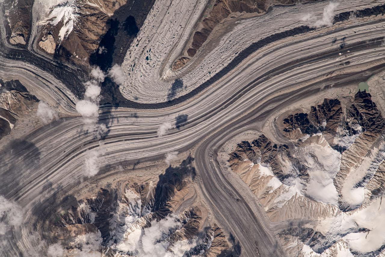 iss069e060266 (Aug. 15, 2023) --- What looks like highways going through a metropolitan area are actually a series of glaciers carving their way through the Karakoram mountain range north of the Himalayas. This photograph was taken from the International Space Station as it orbited 263 miles above.