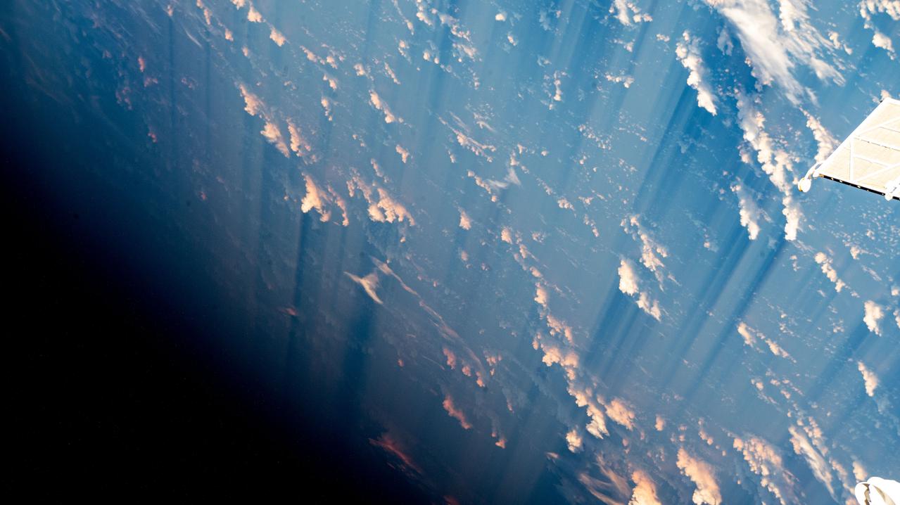 iss069e060352 (August 15, 2023) -- Light pink-orange and white clouds scatter across the blue waters of the Atlantic ocean as the International Space Station orbited 260 miles above.