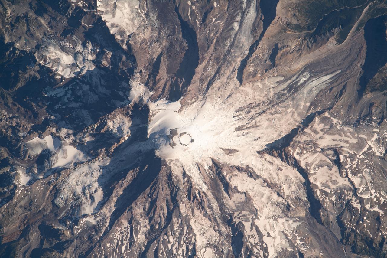iss069e061159 (Aug. 16, 2023) --- Mount Rainier, an active volcano with an elevation of 14,400 feet, is pictured from the International Space Station as it orbited 264 miles above the Evergreen State of Washington.