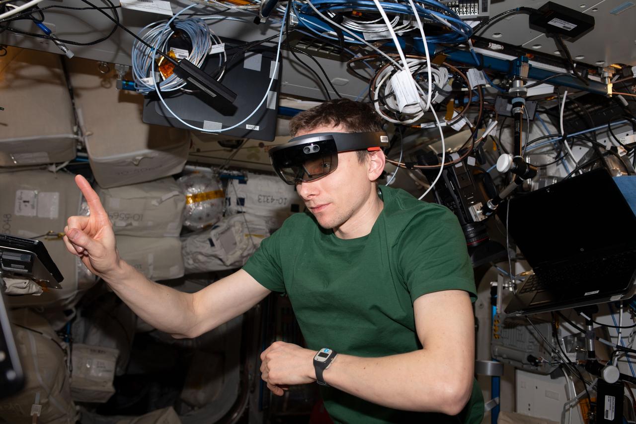 iss069e082115 (Aug. 18, 2023) --- NASA astronaut and Expedition 69 Flight Engineer Woody Hoburg tests the ability to use augmented reality goggles for maintenance aboard the International Space Station.