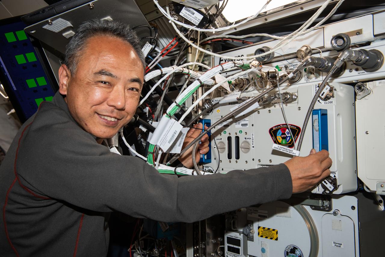 iss069e085467 (Sept. 1, 2023) --- Expedition 69 Flight Engineer and JAXA (Japan Aerospace Exploration Agency) astronaut Satoshi Furukawa removes experiment hardware from inside the Multi-use Variable-g Platform, a biology research device that can generate artificial gravity inside the International Space Station's Kibo laboratory module.