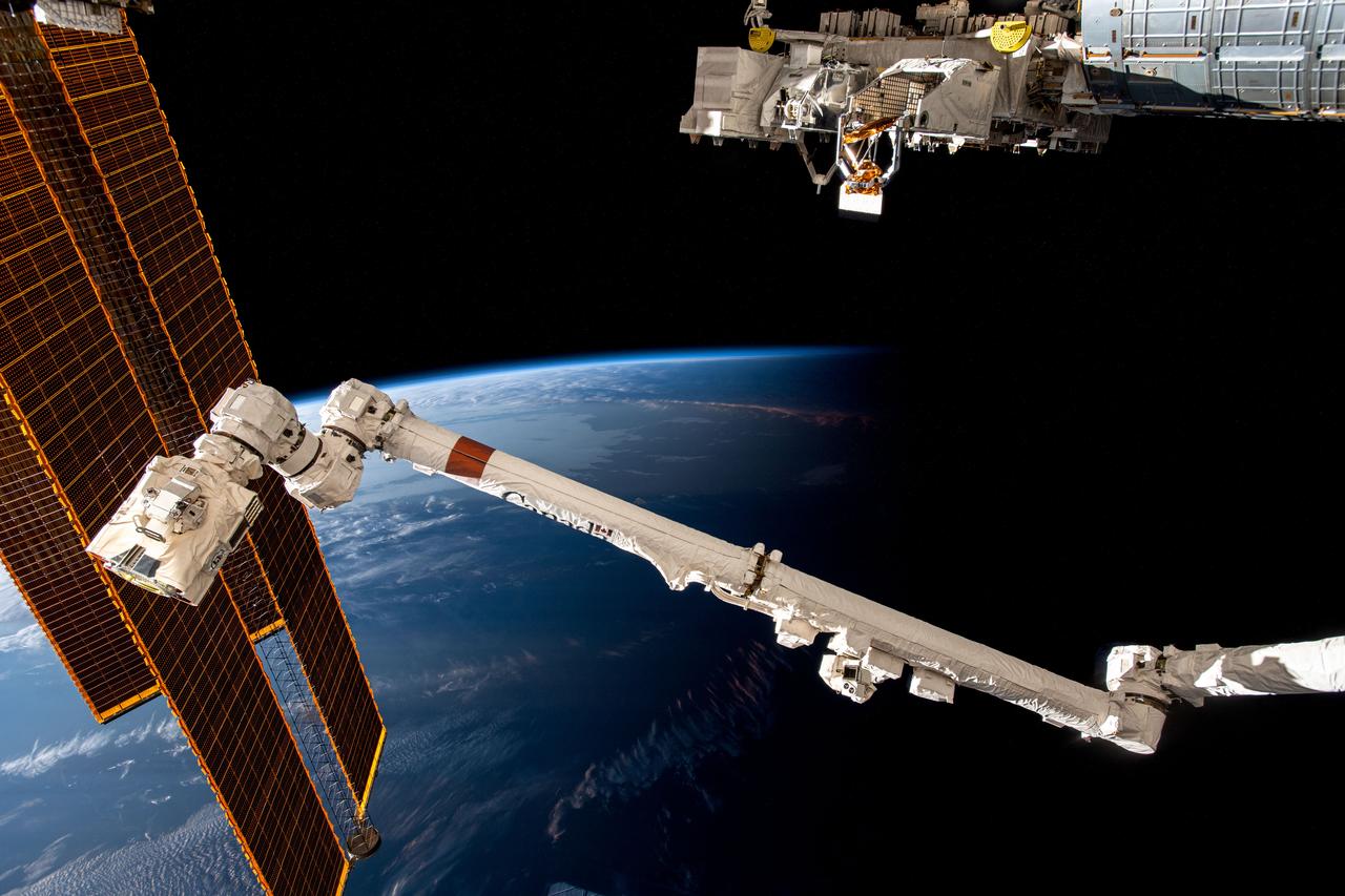 iss069e085991 (Sept. 5, 2023) --- The International Space Station soars 266 miles above the coast of Argentina near the Rio de la Plata as it flies into an orbital sunset. In the foreground from left are, the station's main solar arrays, the Canadarm2 robotic arm, and the Kibo laboratory module's external research platform.