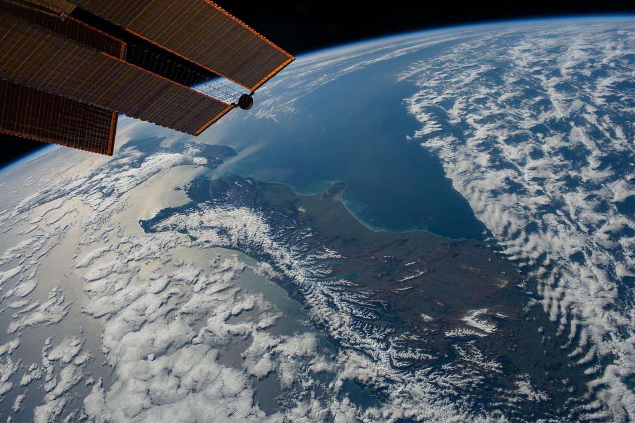 iss069e086875 (Sept. 12, 2023) --- New Zealand, with its snow-capped Southern Alps mountain range, is pictured between two partly cloudy bodies of water, the Tasman Sea and the Pacific Ocean, as the International Space Station orbited 271 miles above.