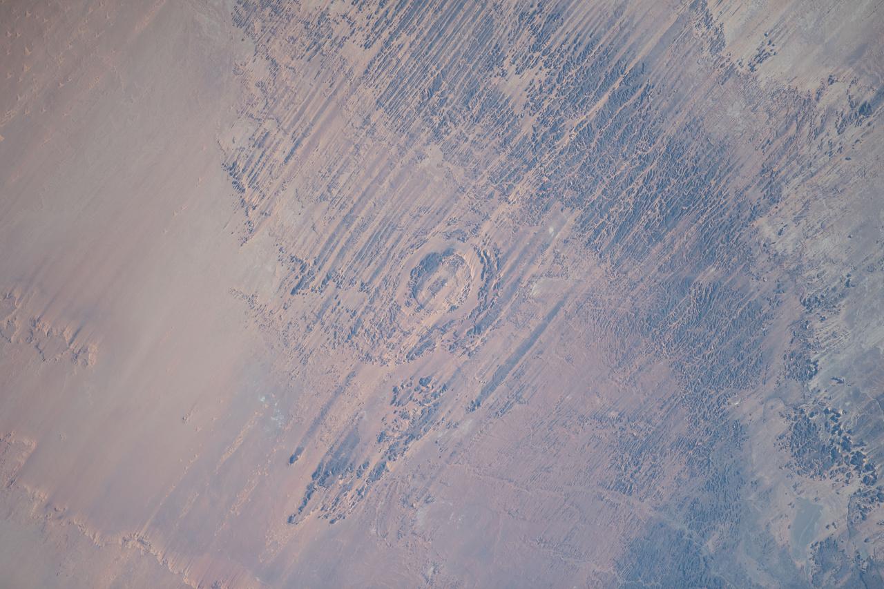 iss069e089635 (Sept. 18, 2023) --- The eroded Aorounga meteorite impact crater, also known as the "Eye of the Desert," in the African nation of Chad is pictured from the International Space Station as it orbited 258 miles above.