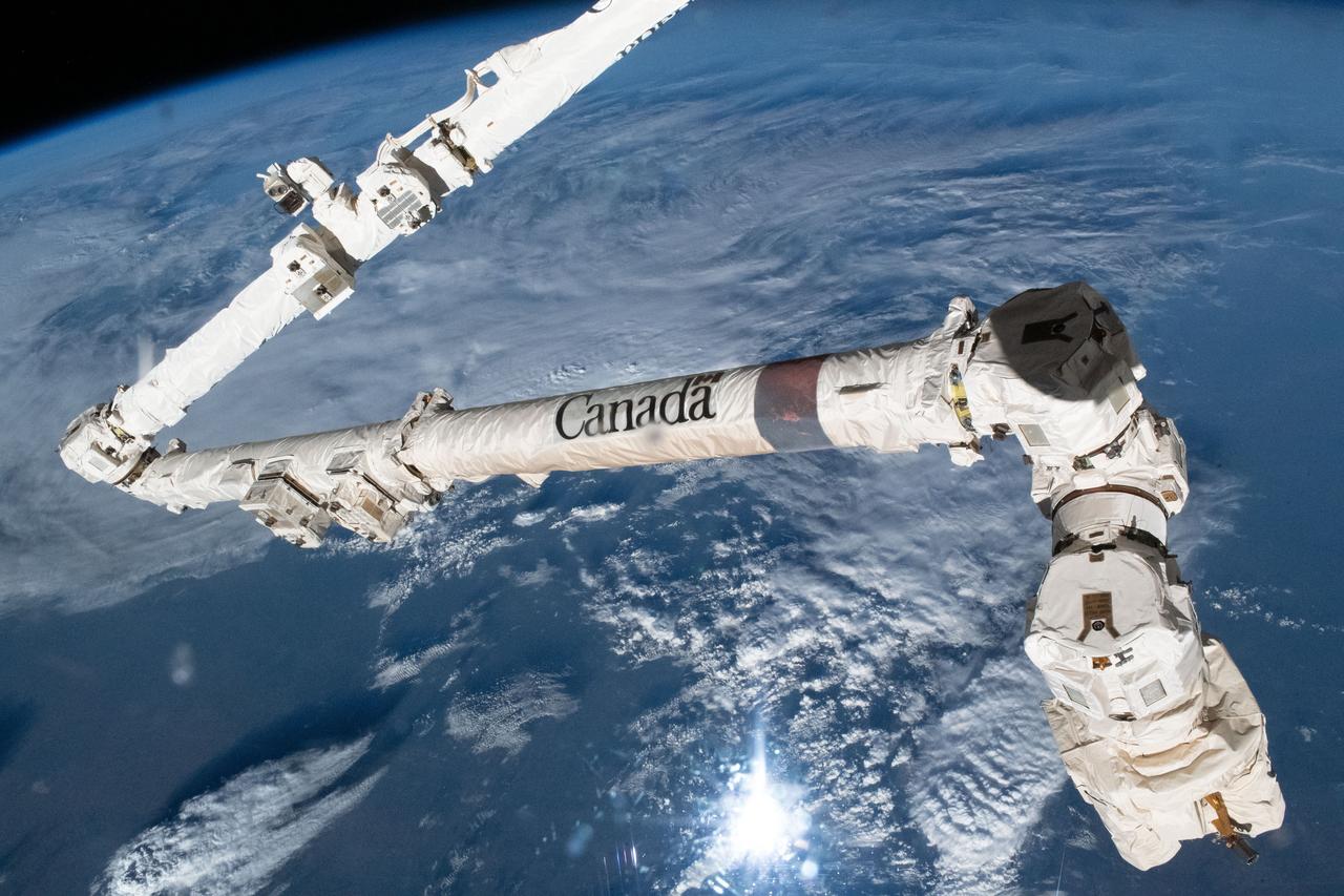 iss069e090130 (Sept. 19, 2023) --- The Canadian Space Agency's major contribution to the International Space Station, the 57.7-foot-long Canadarm2 robotic arm, which can maneuver spacecraft, science payloads, and spacewalking astronauts, is pictured as the orbital lab soared 259 miles above a cloudy Texas.