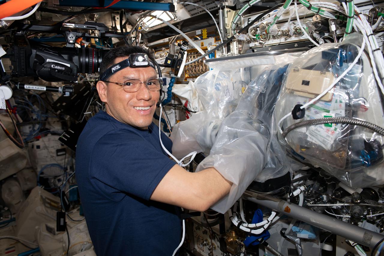 iss069e092048 (Sept. 25, 2023) --- NASA astronaut and Expedition 70 Flight Engineer Frank Rubio uses a glovebag and services the BioFabrication Facility, replacing and installing components inside the research device designed to print organ-like tissues in microgravity and learn how to manufacture whole, fully-functioning human organs in space.