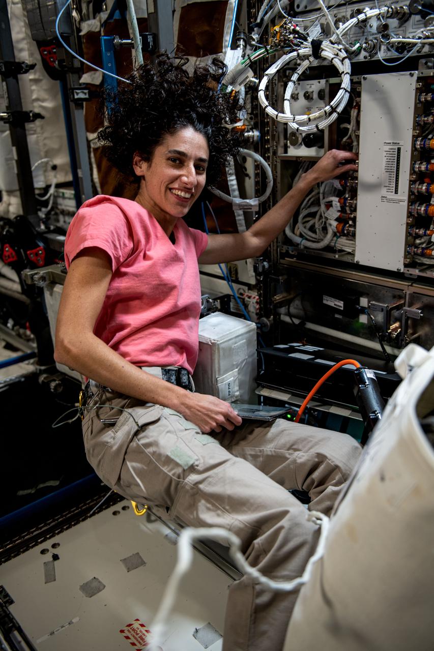 iss069e092237 (Sept. 25, 2023) --- NASA astronaut and Expedition 70 Flight Engineer Jasmin Moghbeli is pictured removing and replacing components inside the Cold Atom Lab aboard the International Space Station. The space physics device enables observations of atoms chilled to temperatures near absolute zero allowing scientists to study fundamental behaviors and quantum characteristics not possible on Earth.