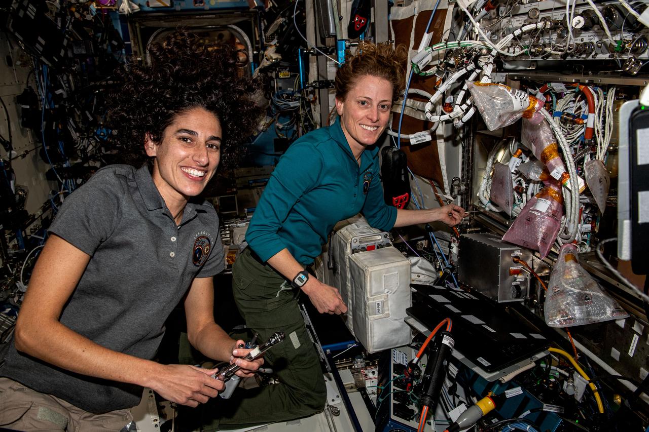 iss069e092348 (Sept. 26, 2023) --- NASA astronauts (from left) Jasmin Moghbeli and Loral O'Hara, both Expedition 70 Flight Engineers, partner together removing and replacing components inside the Cold Atom Lab aboard the International Space Station. The space physics device enables observations of atoms chilled to temperatures near absolute zero allowing scientists to study fundamental behaviors and quantum characteristics not possible on Earth.
