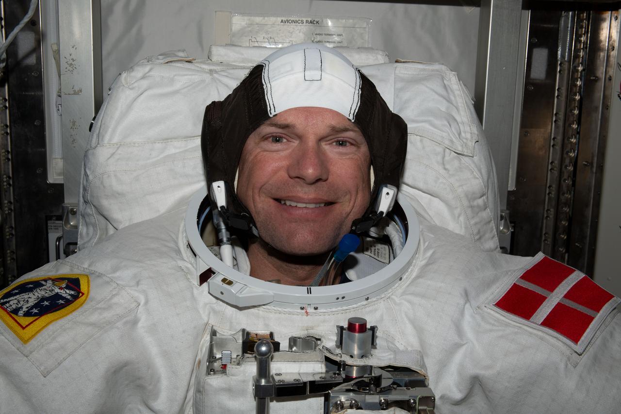 iss070e002415 (Oct. 4, 2023) --- ESA (European Space Agency) astronaut and Expedition 70 Commander Andreas Mogensen is pictured trying on his spacesuit and testing its components aboard the International Space Station's Quest airlock in preparation for an upcoming spacewalk.