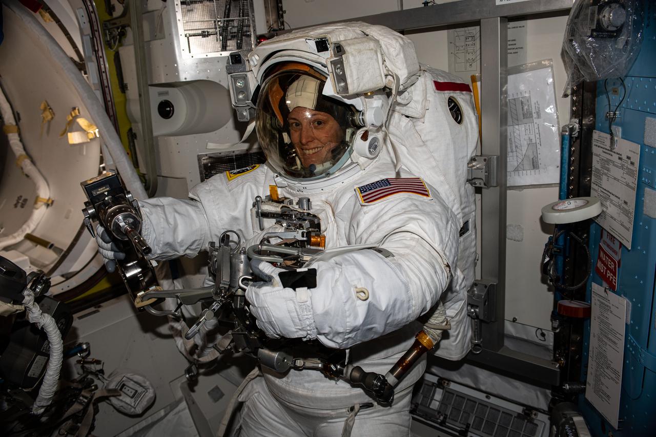 iss070e002889 (Oct. 9, 2023) --- NASA astronaut and Expedition 70 Flight Engineer Loral O'Hara is pictured trying on her spacesuit and testing its components aboard the International Space Station's Quest airlock in preparation for an upcoming spacewalk.