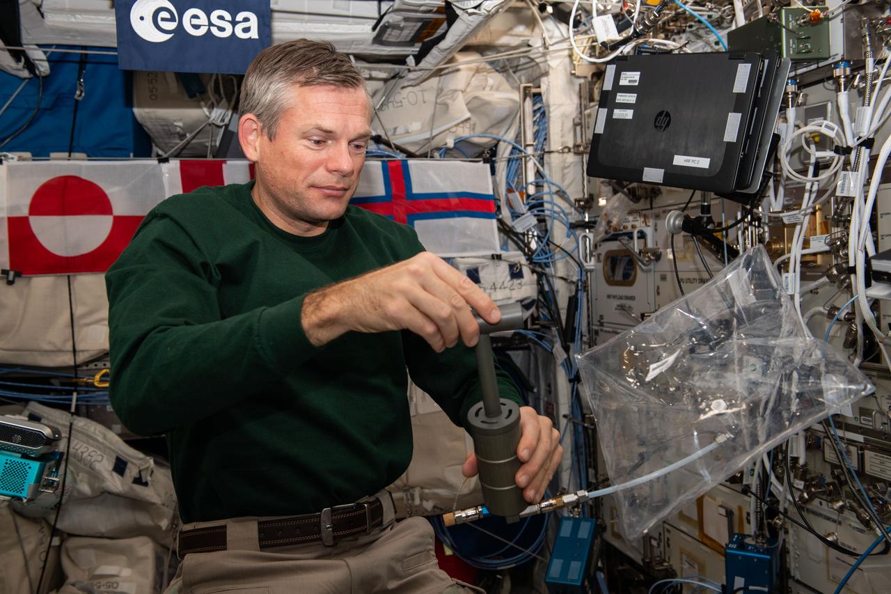 iss070e003131 (10/12/2023) ---  European Space Agency (ESA) astronaut Andreas Mogensen is seen filling an ANITA-2 sampling bag a measurement demonstration. The ANITA-2 is a compact gas analyzer which can analyze and quantify 33 trace contaminants in the atmosphere aboard the ISS automatically.