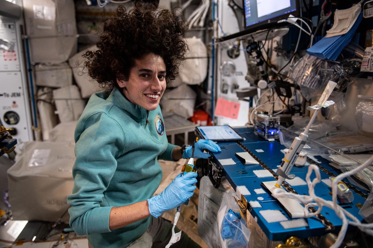 iss070e005386 (Oct. 18, 2023) --- NASA astronaut and Expedition 70 Flight Engineer Jasmin Moghbeli uses a portable DNA detection device that can be found in laboratories and classrooms on Earth. She was identifying bacteria extracted from water samples collected aboard the International Space Station. Known as BioMole, the study is demonstrating the ability to monitor the spacecraft’s microbial environment without sending samples back to Earth for analysis.