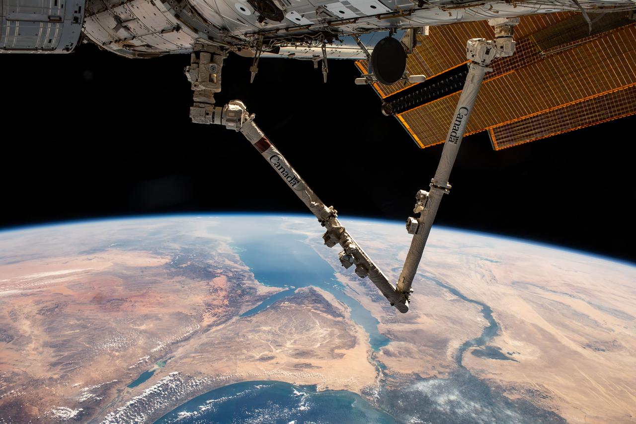 iss070e007599 (Oct. 20, 2023) --- The Canadarm2 robotic arm extends from the International Space Station as it orbited 261 miles above Turkey. Below, the Sinai Peninsula, the Red Sea, and the Nile River Delta are pictured leading toward the Mediterranean Sea at bottom.