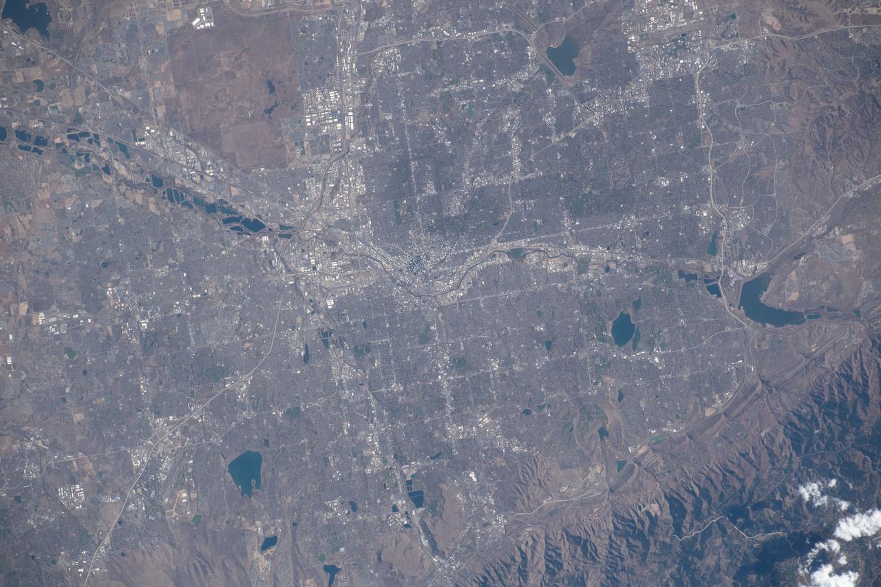 iss070e008429 (Oct. 22, 2023) --- Denver, Colorado, split by the South Platte River and next to the Rocky Mountains, is pictured from the International Space Station as it orbited 262 miles above the Centennial State.
