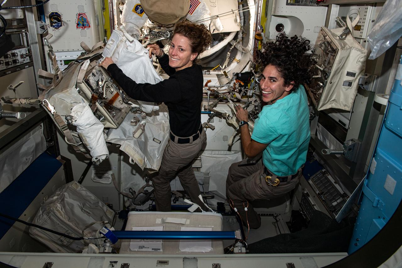 iss070e014305 (Oct. 27, 2023) --- Expedition 70 Flight Engineers (from left) Loral O'Hara and Jasmin Moghbeli, both NASA astronauts, configure spacewalking tools inside the International Space Station's Quest airlock.