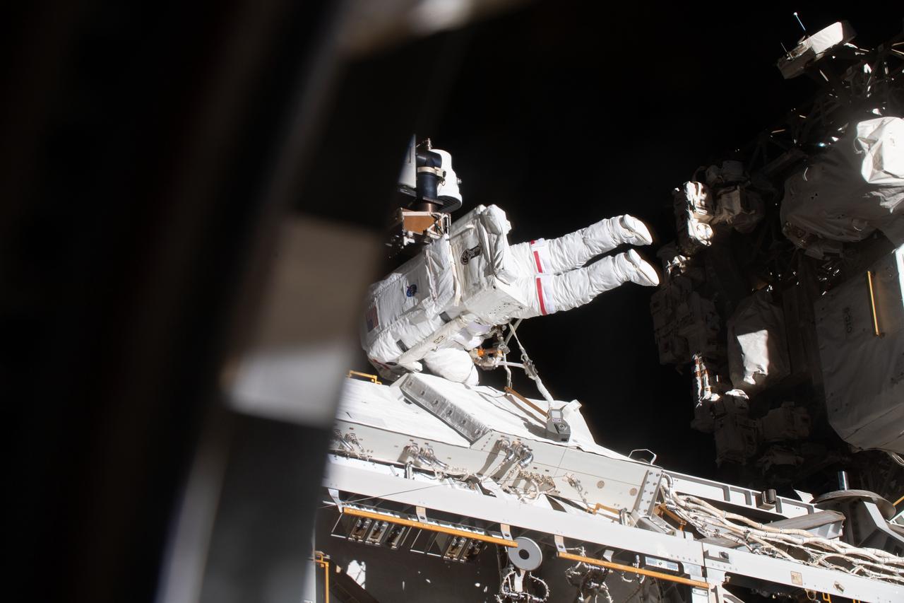 iss070e015430 (Nov. 1, 2023) --- NASA astronaut and Expedition 70 Flight Engineer Jasmin Moghbeli is pictured tethered to the International Space Station during a spacewalk to replace one of the 12 trundle bearing assemblies on the port solar alpha rotary joint, which allows the arrays to track the Sun and generate electricity to power the station.