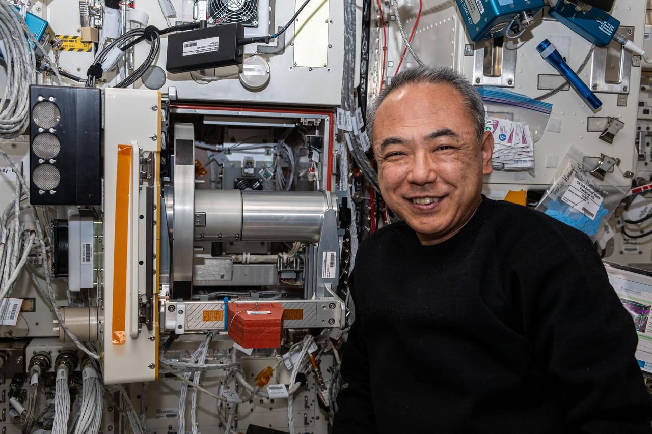iss070e015767 (Oct. 30, 2023) --- JAXA (Japan Aerospace Exploration Agency) astronaut and Expedition 70 Flight Engineer Satoshi Furukawa poses for a portrait next to the Cell Biology Experiment Facility Incubator Unit inside the International Space Station's Kibo laboratory module.