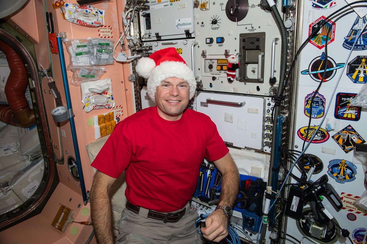 iss070e022023 (Nov. 9, 2023) --- ESA (European Space Agency) astronaut and Expedition 70 Commander Andreas Mogensen gets ready for the Christmas season and poses for a fun portrait wearing a Santa Claus hat.