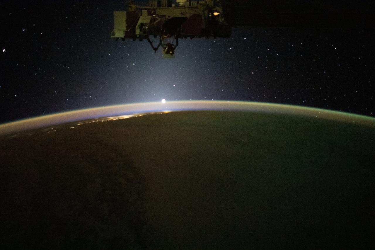 iss070e022731 (Nov. 11, 2023) --- The sun's first rays begin illuminating Earth's atmosphere in this photograph from the International Space Station as it orbited 262 miles above the Pacific Ocean off the coast of California.