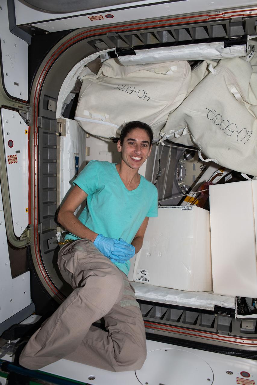 iss070e025062 (Nov. 16, 2023) --- NASA astronaut and Expedition 70 Flight Engineer Jasmin Moghbeli works in the International Space Station's Tranquility module clearing hardware and making space inside the NanoRacks Bishop airlock.